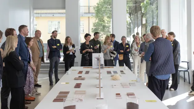 People standing around a table with samples and products